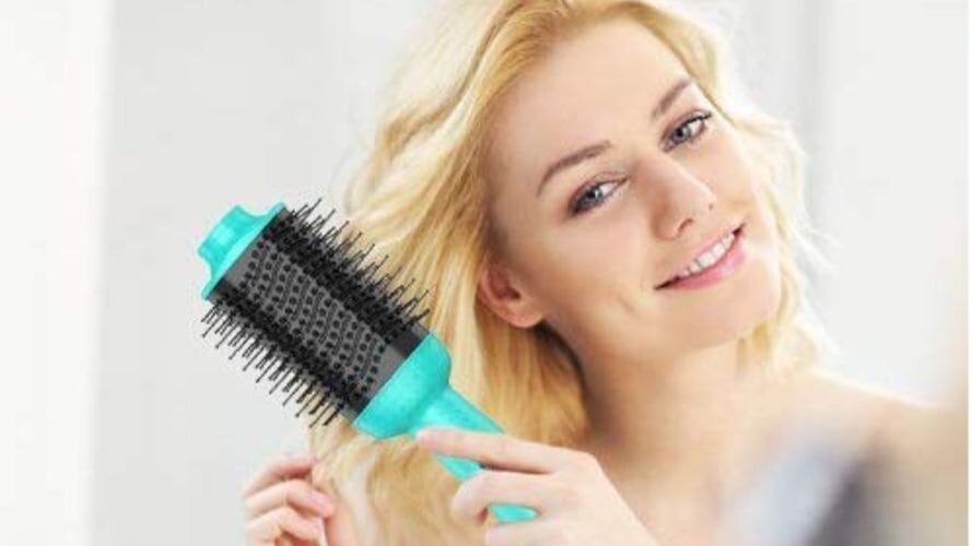 Girl drying her hair with a brush
