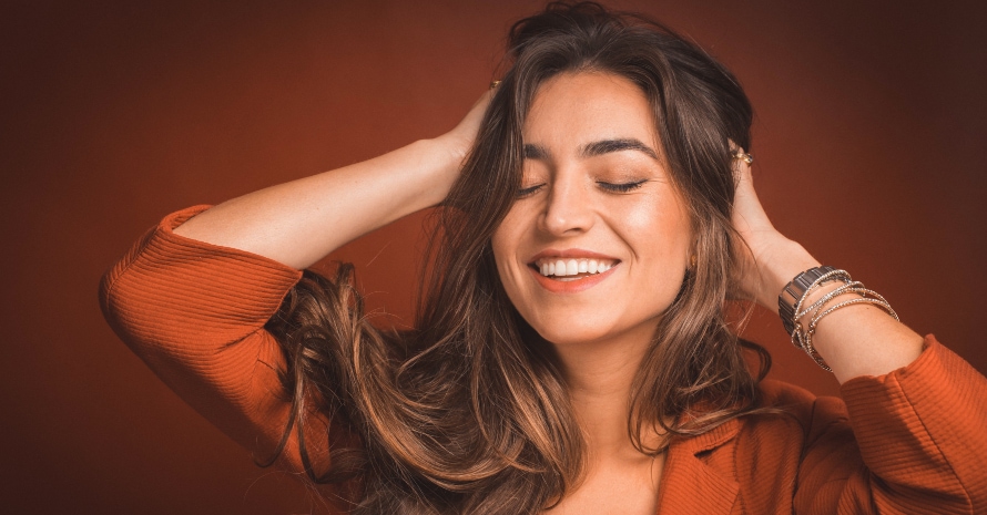 Girl lifts her hair with her hands