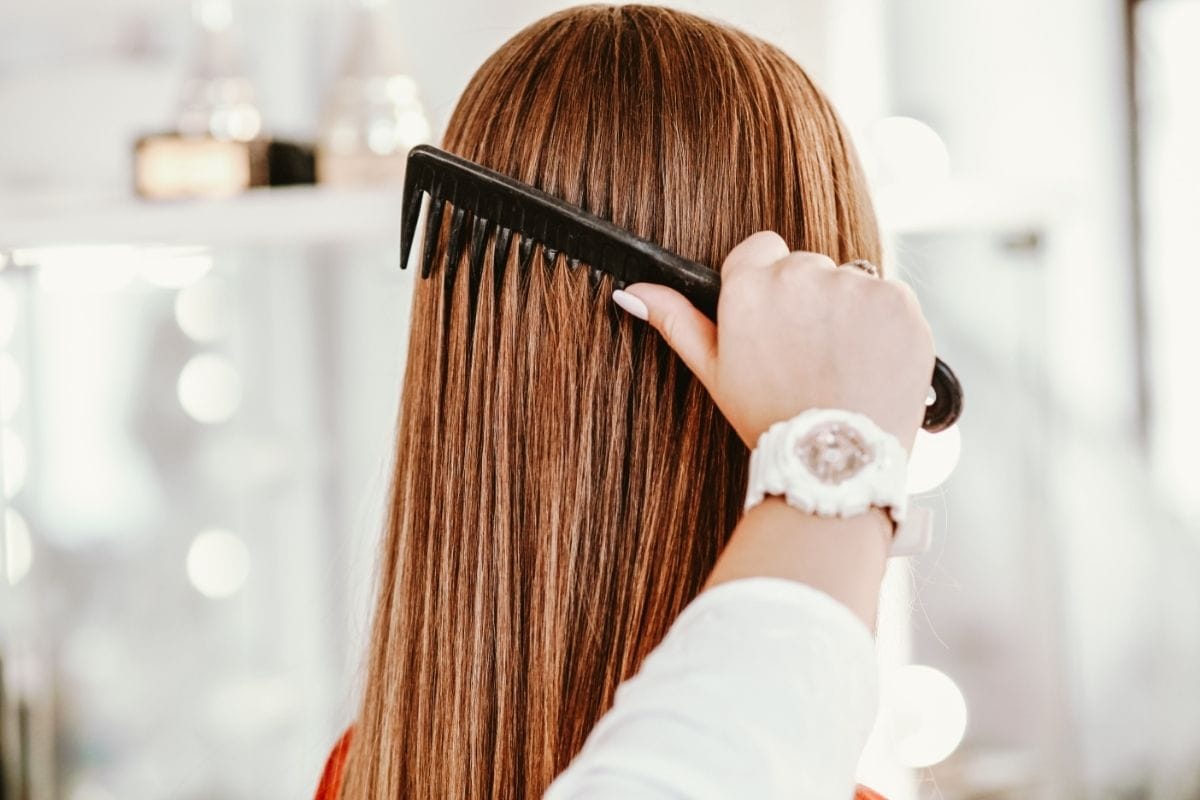 woman's hair being combed