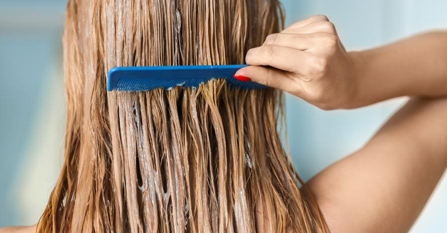 Girl combing her hair covered with mask