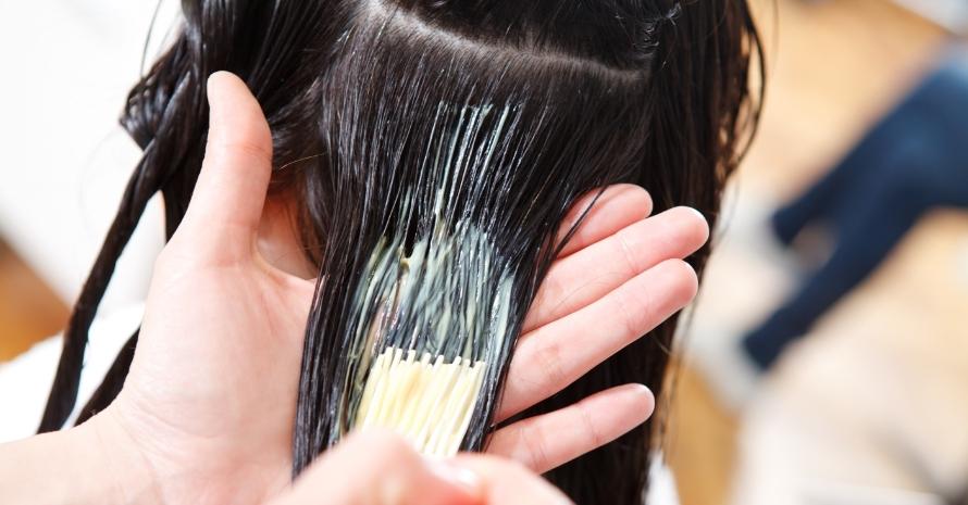 Woman bleaching girl's hair