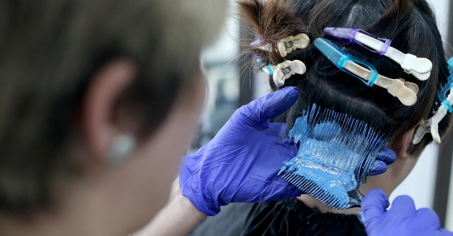 Woman dyeing her hair in a salon