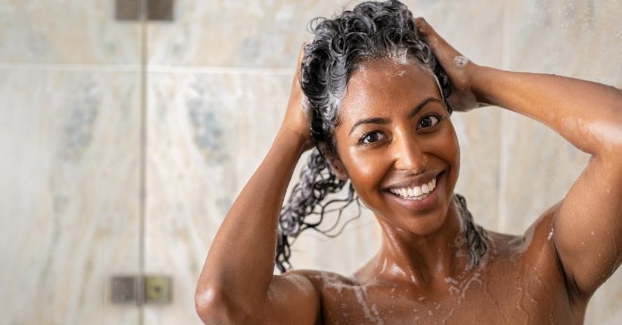 Woman washing hair with shampoo