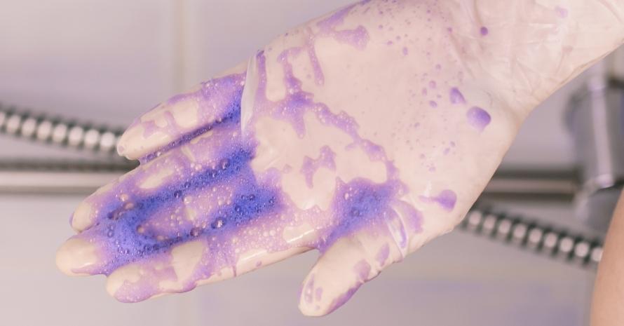 purple shampoo on white latex gloves