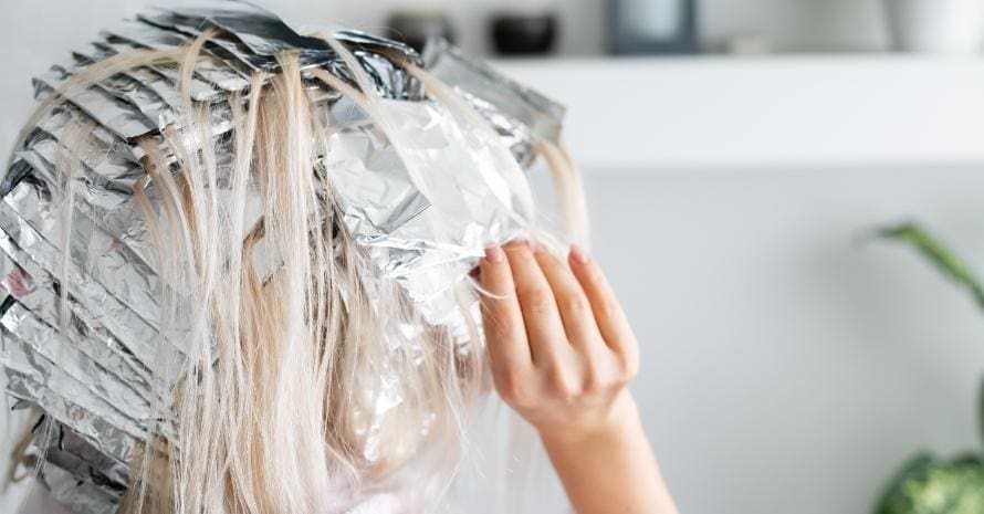 woman dyes her hair foil at home