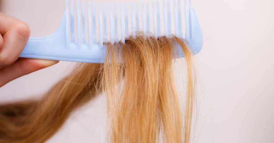 Blonde woman with her damaged dry hair