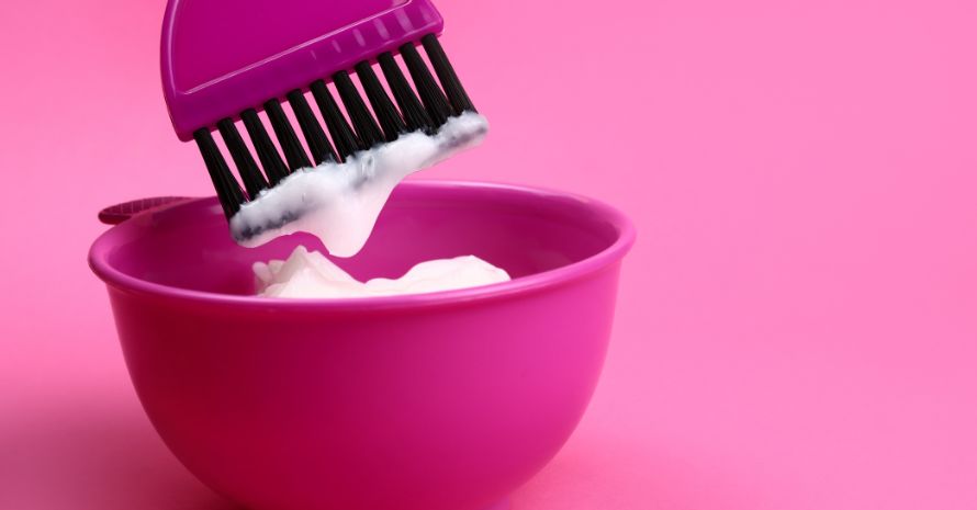 Mixing hair dye in plastic bowl. Hair coloring